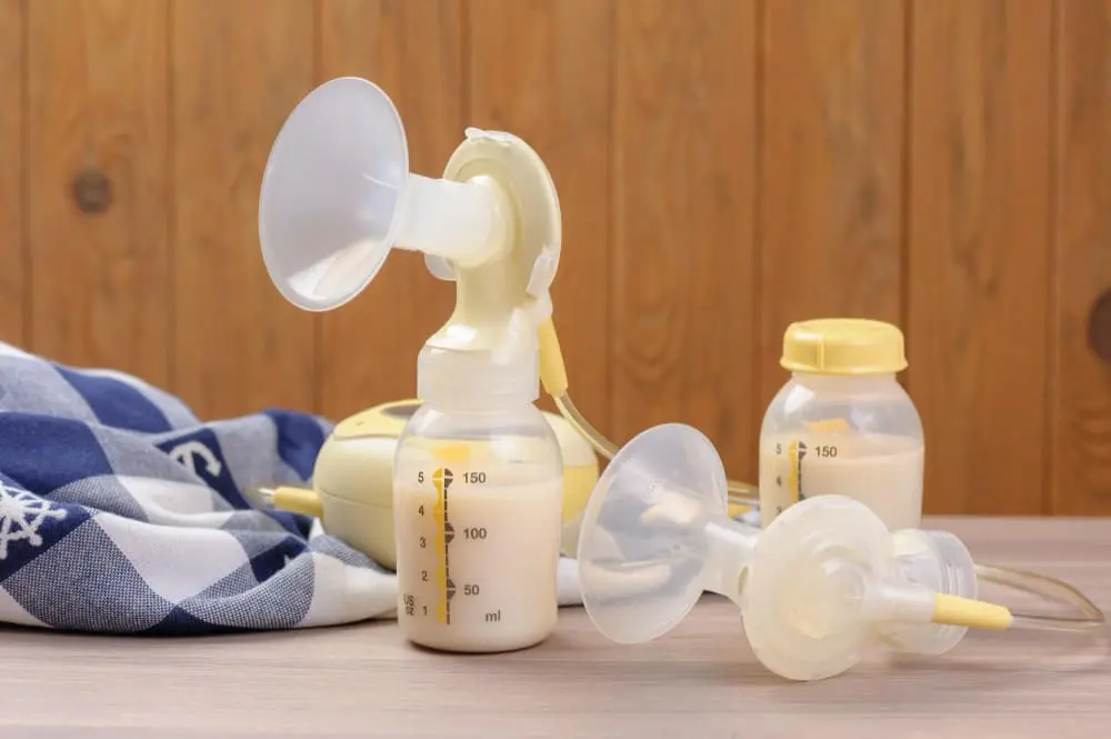 Woman adjusting breast pump flange size, highlighting the importance of finding the perfect fit.