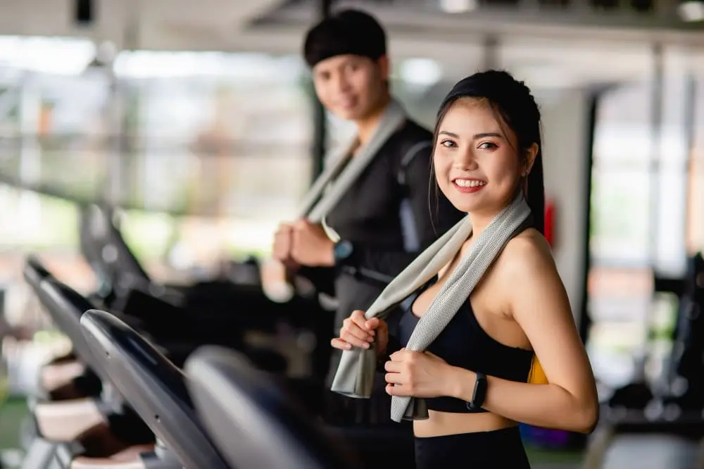 Person comparing treadmills in a store, learning how to choose a treadmill