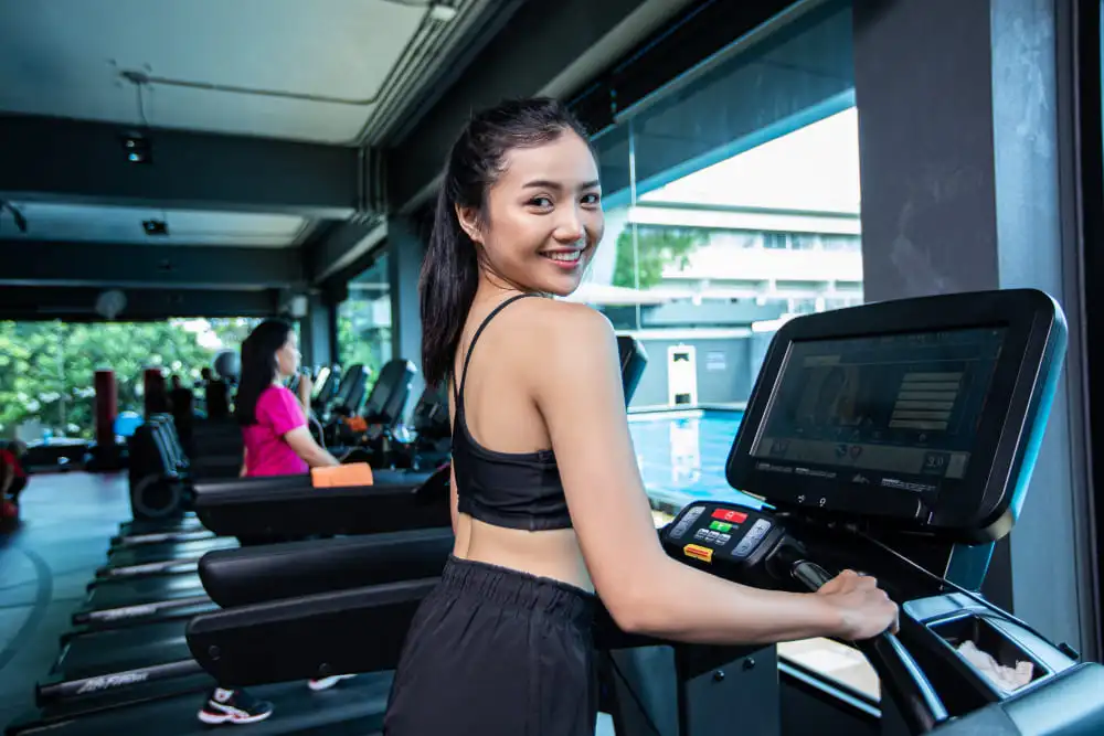 Person using treadmill buying guide to select the best treadmill